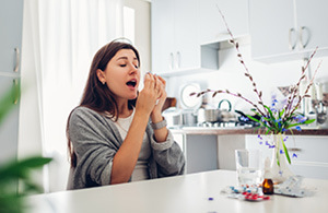 Woman sneezing